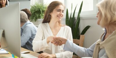 Shaking hands while sitting at desk