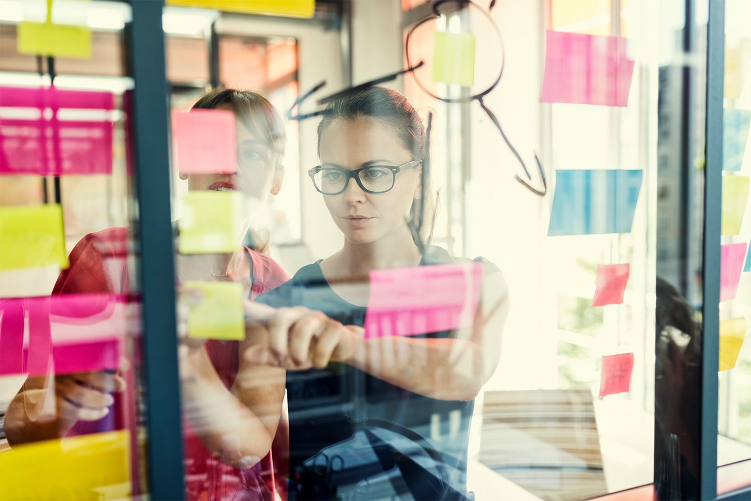 two engineers reviewing sticky notes