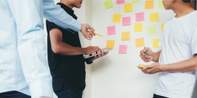 Men standing in front of Agile whiteboard