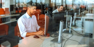 Working in a call center - view through a glass window