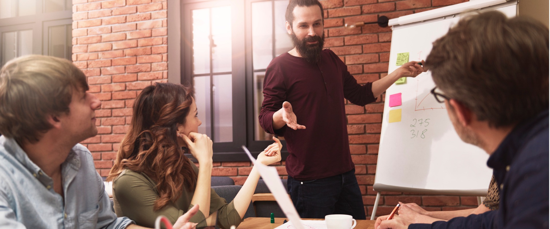 Man presenting ideas to coworkers