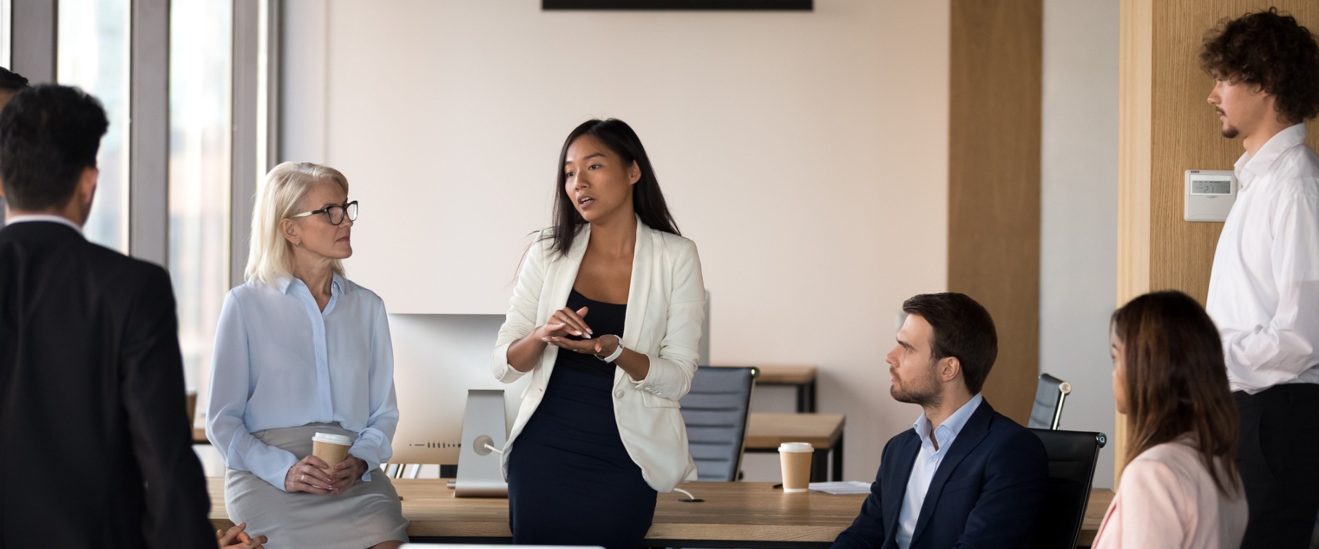 Woman speaking to her coworkers