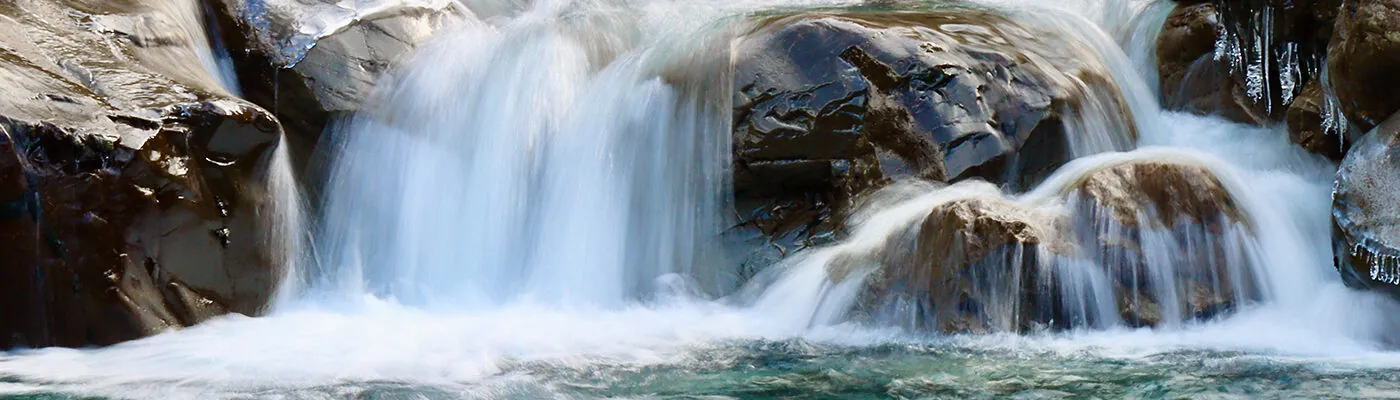 water falling off of a rock