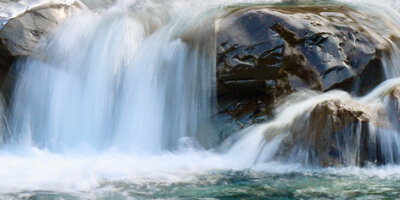 water falling off of a rock