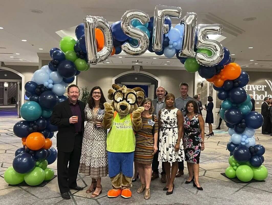 RevGen volunteers pose with the Denver Public Schools mascot at the DPS Scholarship Gala