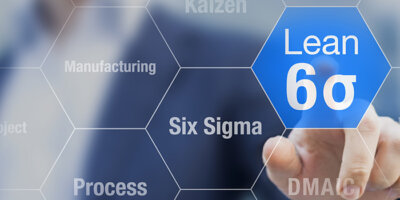 A man selects an icon representing Lean and Six Sigma from a panel of icons.