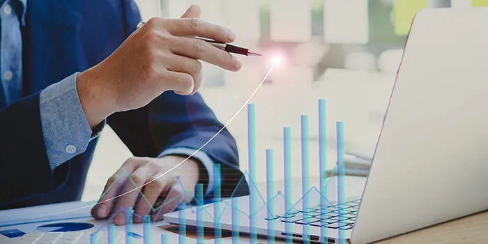 Businessman points to a holographic report of a financial growth line