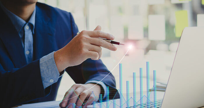 Businessman points to a holographic report of a financial growth line